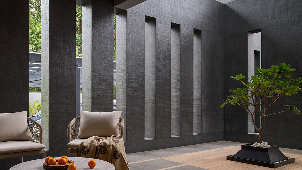 Riga dark textured sintered surface panels used as exterior wall cladding with deep vertical relief and natural light interaction